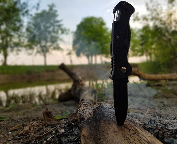knife stabbed into log