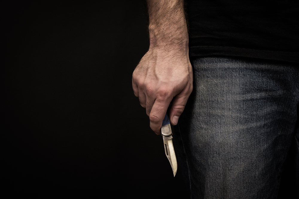 man holding an open pocket knife
